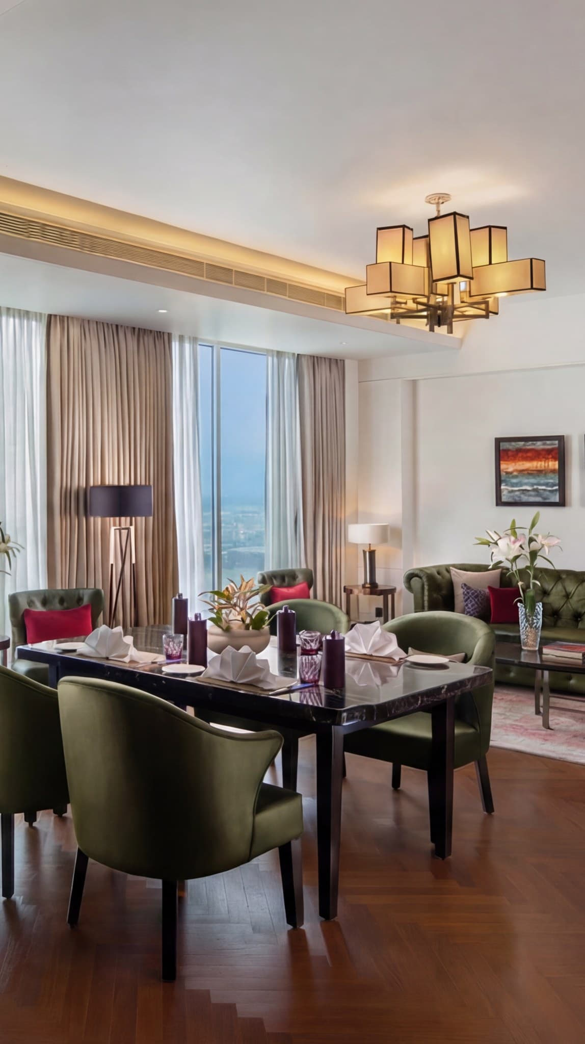 A suite living and dining room with floor-to-ceiling windows
