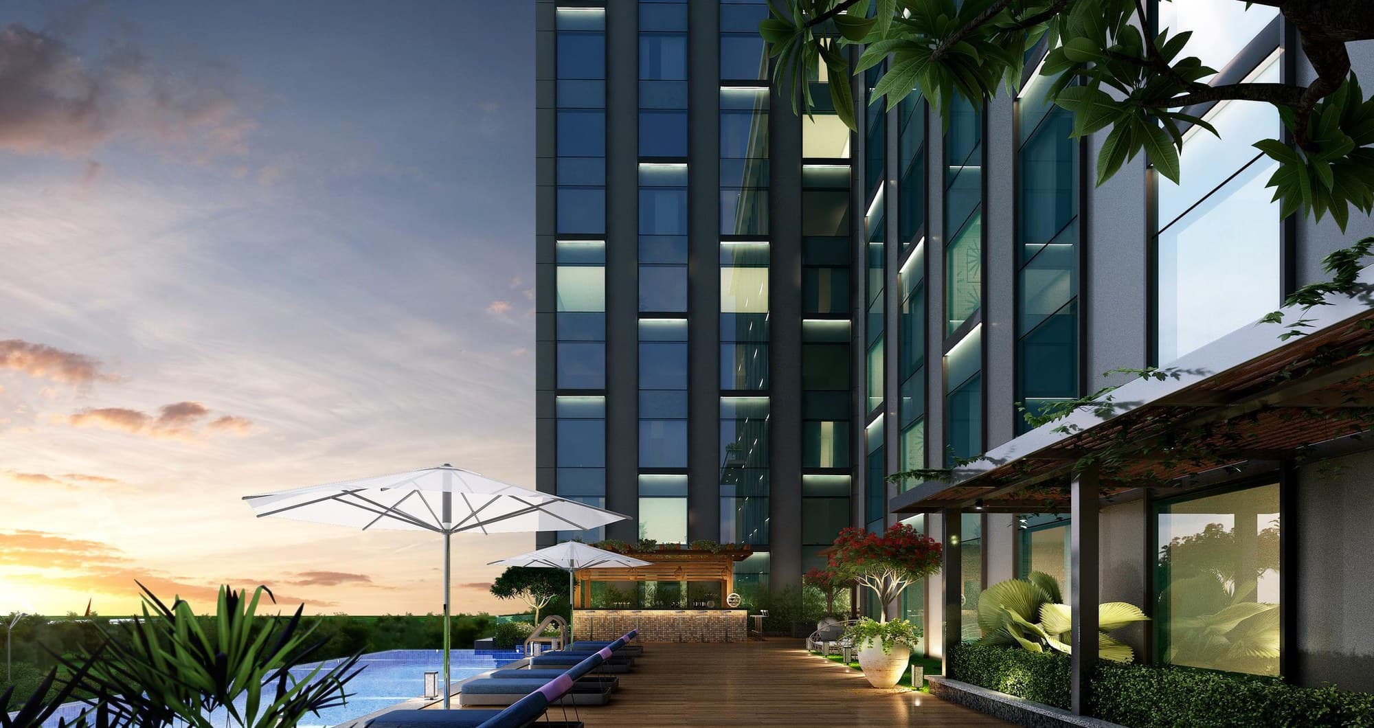 The pool terrace at sunset, with the suite towers rising behind